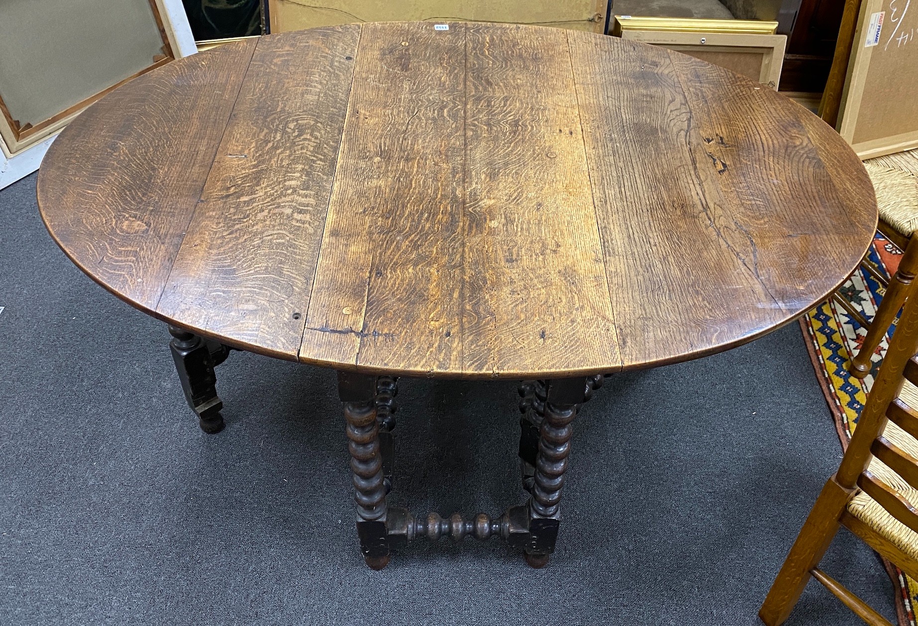 An early 19th century oak bobbin leg gateleg dining table, length 154cm extended, width 108cm, height 76cm